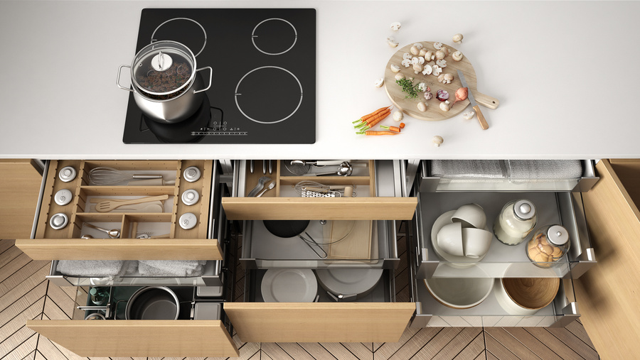 Opened wooden kitchen drawer with accessories inside, solution for kitchen storage and organizing, cooking, modern interior design